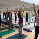 Students yoga pose raised arms
