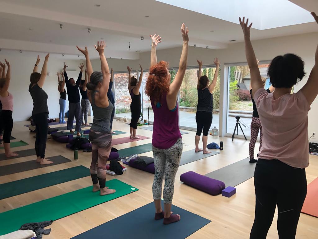 Students yoga pose raised arms